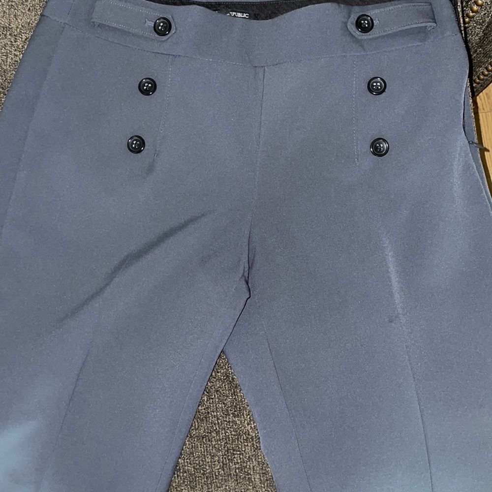 Grey wide legged trousers open to trades